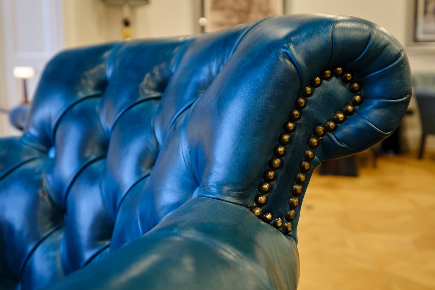 A close up of a drawer slightly open with a brass edging and handle