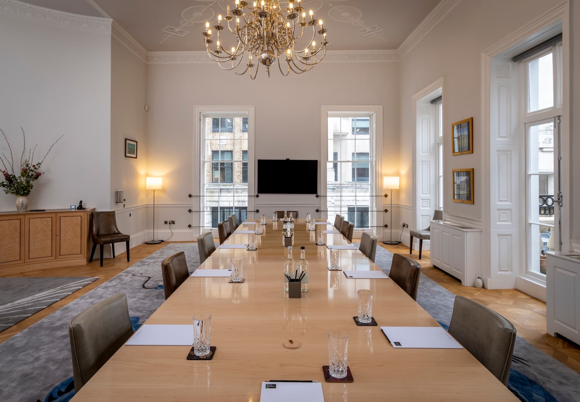 A close-up photo of a bespoke dark wood table corner with intricate decoration